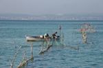 Fishermen Checking Their Nets At Lake Garda Stock Photo