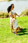 Family Holding Hands While Walking Stock Photo