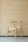 Wooden Chair With Wooden Wall In Background Stock Photo