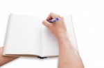 A Hand Is Writing On Blank Page Notebook Stock Photo