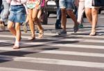 Feet Of The Pedestrians Crossing On City Street Stock Photo