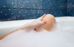 Female Leg In The Bath Stock Photo