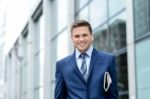 Handsome Businessman Holding A Newspaper Stock Photo