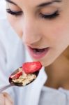 Woman Eating Cereals In The Morning Stock Photo