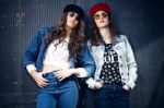 Young Beautiful Girls With Denim Suit In A Urban Background Stock Photo