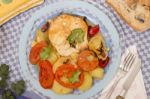 Fish With Potatoes And Tomato Stock Photo