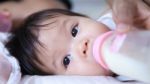 Pretty Baby Girl Is Drinking Milk Stock Photo