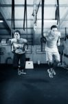 Young Gymnasts Training On Rings On A Dark Background Stock Photo