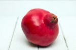 Fresh Pomegranate Fruit Isolated On A White Wooden Background Stock Photo