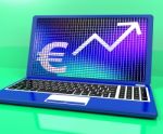 Euro Sign And Up Arrow On Laptop For Earnings Or Profit Stock Photo