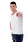 Young Smiling Guy Pointing You Out Stock Photo