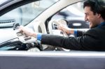 Man Accessing Road Map Via Gps Technology Stock Photo