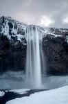 View Of Seljalandfoss Waterfall In Winter Stock Photo