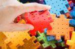 Hand On Jigsaw Puzzle Game Stock Photo