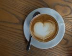 A Cup Of Coffee With Heart Pattern In A White Cup Stock Photo