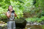 Girl Using Binoculars In Forest Stock Photo