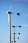 Green Renewable Energy Concept - Wind Generator Turbines On Blue Stock Photo