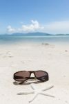 Sunglesses And Starfish On Sand Beach Stock Photo