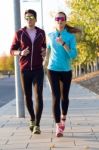 Beautiful Couple Running In The Street Stock Photo