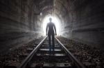 Man In A Tunnel Looking Towards The Light Stock Photo