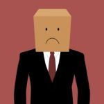 Cardboard Businessman With An Unhappy Face Stock Photo