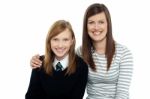 Mom Posing With Arms Around Her Cute Daughter Stock Photo