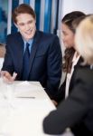 Partners At Workplace Discussing An Idea Stock Photo