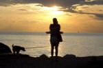 Woman Shooting With Camera At Sunset Stock Photo