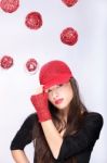 Woman With Red Hat Between Red Balls Stock Photo