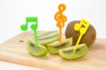 Fresh Sliced Kiwi Fruit And Knife On Wooden Board Stock Photo