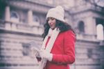 Woman In Red Coat And Wool Cap And Gloves With Smartphone In Han Stock Photo