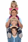 Attractive Smiling Family Of Four Posing In A Single Line Stock Photo