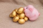 Pink Piggy Bank Climb On Heap Of Golden Easter Egg Stock Photo