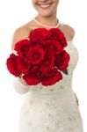 Smiling Young Bride Holding Out A Rose Bouquet Stock Photo