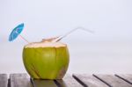 Coconut Water Drink Served In Coconut With Drinking Straw On The Stock Photo