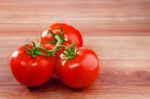 Fresh Three Of Tomato On Top Wood Table With Copy Space For Fill Stock Photo