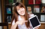 Portrait Of Thai Adult Student University Uniform Beautiful Girl Using Her Tablet Stock Photo