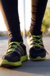 Man Shoes Running On The Asphalt With The Sky In The Background Stock Photo