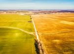 Spring Green And Brown Agricultural Fields. Village On Backgroun Stock Photo