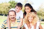 Parents Giving Kids Piggy Back Ride Stock Photo