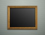 Empty Golden Vintage Frame On Wallpaper Background Stock Photo