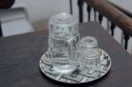 Glasses Of Water Are Placed On A Plate At The Wooden Table Stock Photo