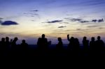 Silhouette Of Many People Watching Sunset Stock Photo