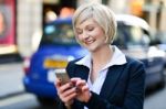 Happy Woman Using Her Mobile Phone Stock Photo