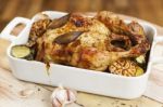 Roasted Chicken With Garlic And Potatoes Stock Photo