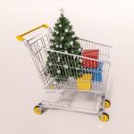 Shopping Cart Full Of Purchases In Packages And Christamas Tree Stock Photo