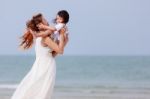 Mom And Son Play On Beach Stock Photo