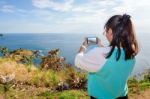 Woman Taking Photograph With Smartphone Stock Photo