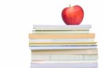 Light Red Apple On Book Stack Stock Photo