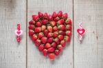 Strawberry And Heart On Wooden Stock Photo